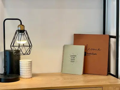 a book and a lamp on a wooden shelf at Special! New Downtown Mtn View Free Parking 2b&2b in Canmore