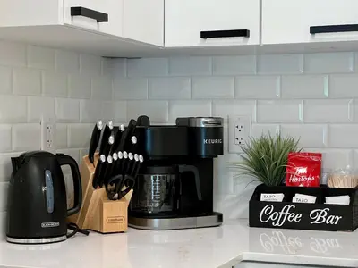 a coffeemaker on a kitchen counter with a coffee maker at Special! New Downtown Mtn View Free Parking 2b&2b in Canmore