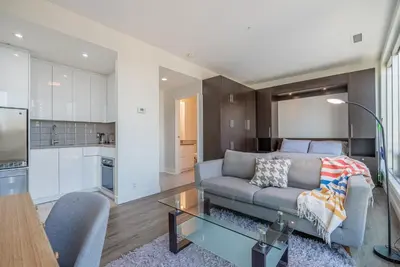 a living room with a couch and a table at Gorgeous City Views Central Studio Walk to Seawall in Vancouver