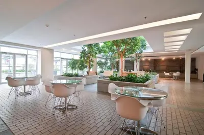 a lobby with tables and chairs in a building at Gorgeous City Views Central Studio Walk to Seawall in Vancouver