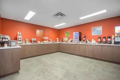 a store with orange walls and wooden counters in a store at Comfort Inn & Suites in Campbell River