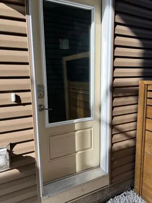 a door with a window on the side of a house at Beautiful suite in Balzac