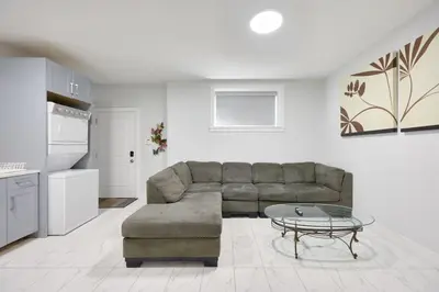 a living room with a couch and a table at Basement Suite In Vancouver in Vancouver