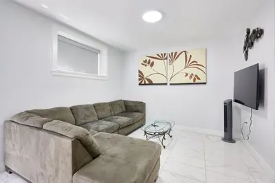a living room with a couch and a tv at Basement Suite In Vancouver in Vancouver