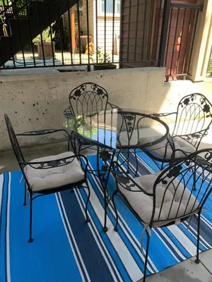 a glass table and chairs on a patio at Cozy 1BR Near Skytrain - Explore Vancouver Easily in Vancouver