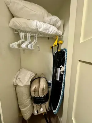 a room with a closet with pillows and a bed at Cozy 1BR Near Skytrain - Explore Vancouver Easily in Vancouver