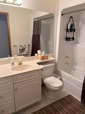 a bathroom with a toilet and a sink and a shower at Luxury bungalow in NW Calgary in Calgary