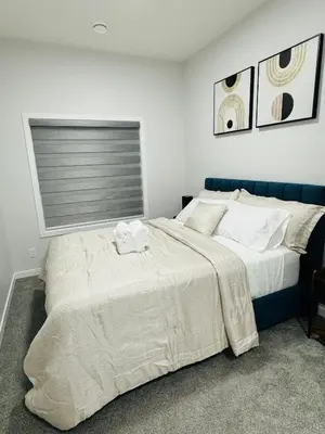 a bedroom with a large bed and a window at The Glacier Royale - 1 Bed Suite in NW Calgary in Calgary