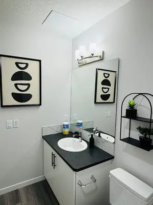 a bathroom with a sink and a toilet at The Glacier Royale - 1 Bed Suite in NW Calgary in Calgary