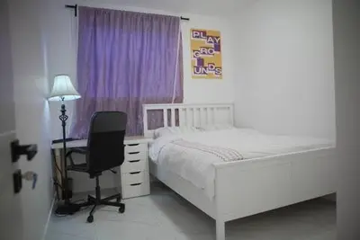 a bedroom with a bed and a desk and a chair at New Luxury Walkout Suite Near University-BY ROOM in Calgary