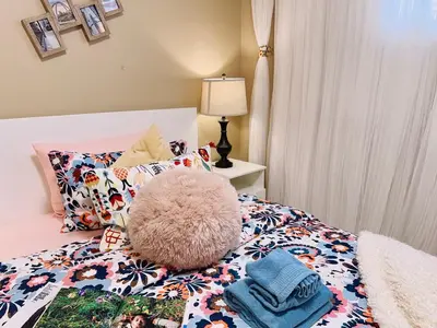 a bedroom with a bed with a stuffed animal on it at Scorpio House Langley - Semi-basement Suite in Langley