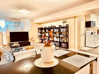 a living room with a vase on a table at Scorpio House Langley - Semi-basement Suite in Langley