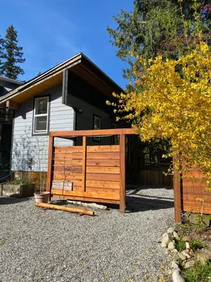 a wooden gate in front of a house at Little Cabin in Middlepoint in Halfmoon Bay