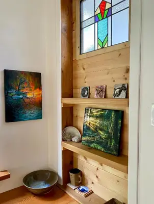 a room with wooden walls and a stained glass window at Little Cabin in Middlepoint in Halfmoon Bay