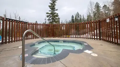 a small swimming pool with a wooden fence at Stone Creek Chalet by Fernie Lodging Company in Fernie