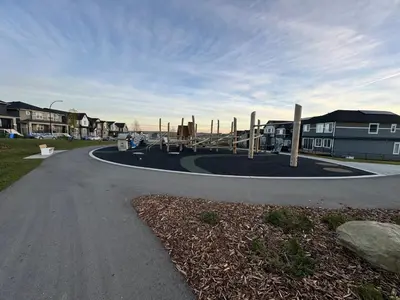 a park with a playground in the middle of a road at Chic & Cozy 2-BR Suite at Glacier Ridge NW Calgary in Calgary
