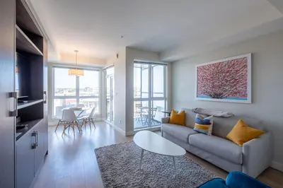 a living room with a couch and a table at Stylish Modern Apartment In The Heart Of Old Town Victoria in Victoria