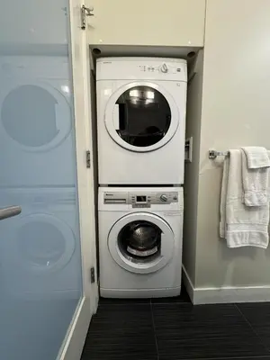 a washer and dryer in a small room at Stylish Modern Apartment In The Heart Of Old Town Victoria in Victoria
