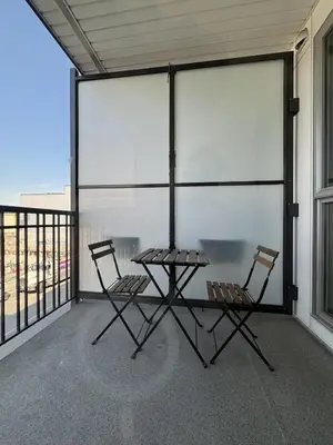 two chairs and a table on a balcony at Stylish Modern Apartment In The Heart Of Old Town Victoria in Victoria