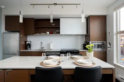 a kitchen with a table with plates on it at Chic And Cozy Apartment In Old Town in Victoria