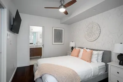 a bedroom with a bed and a ceiling fan at Chic And Cozy Apartment In Old Town in Victoria