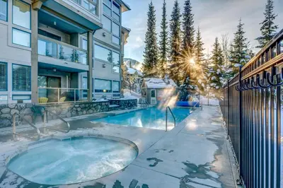 a hot tub in the backyard of a house at Greystone Lodge 214 Ski-in Out in Whistler