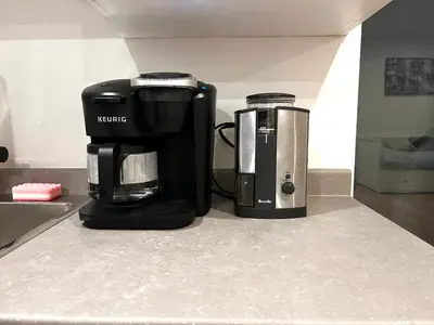 a coffeemaker and a coffee maker sitting on a counter at Brand new suite in langley close to everything in Langley