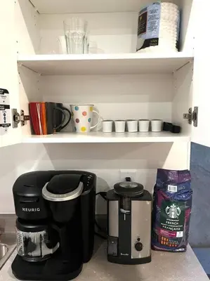 a coffee maker on a shelf in a kitchen at Brand new suite in langley close to everything in Langley