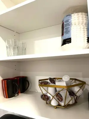 a shelf in a kitchen with cups and other items at Brand new suite in langley close to everything in Langley