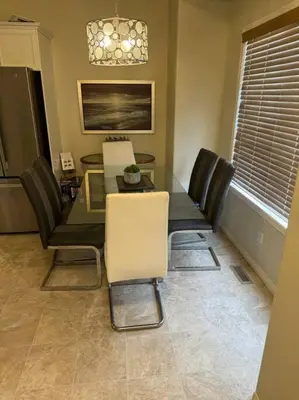 a dining room with a table and chairs at Spacious 3bedrm for family or business travellers in Red Deer
