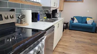 a kitchen with a sink and a stove at Elegant 4-Bedroom Family Home Master in Calgary