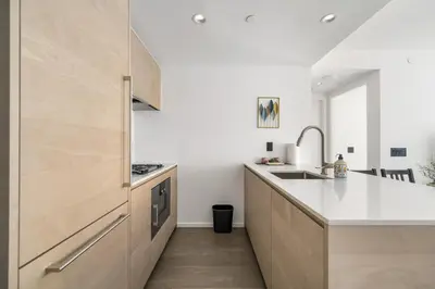 a kitchen with a sink and a counter top at Luxury High-Rise Condo with Stunning Views in Vancouver