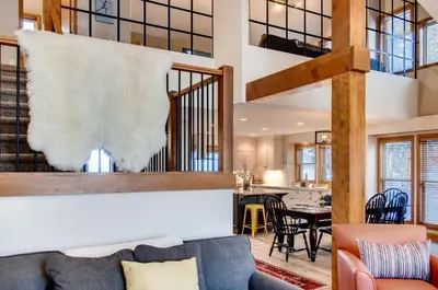 a living room with a couch and a staircase at Moonshine Crescent 385 by Okanagan Premier in Big White