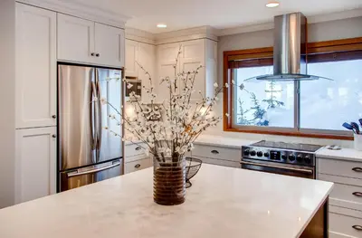 a kitchen with a vase with flowers on a counter at Moonshine Crescent 385 by Okanagan Premier in Big White