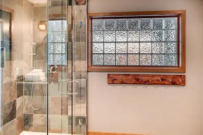 a bathroom with a shower and a window at Moonshine Crescent 385 by Okanagan Premier in Big White