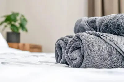 a blanket laying on top of a bed at Modern Studio Unit - Close to DT in Edmonton