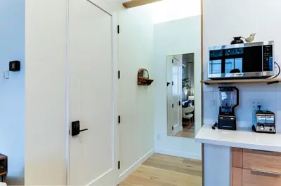 a kitchen with a counter with a microwave on a wall at Modern industrial suite in Grand Forks in Grand Forks