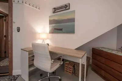 a desk with a white chair and a lamp at Christina Lake Lakefront, Hot Tub, Amazing Views in Christina Lake