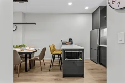 a kitchen and dining room with a table and chairs at ML4- Private Rooftop Hot Tub Oasis- Entire townhouse with MTN View in Canmore