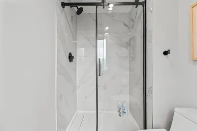 a shower with a glass door in a bathroom at ML4- Private Rooftop Hot Tub Oasis- Entire townhouse with MTN View in Canmore