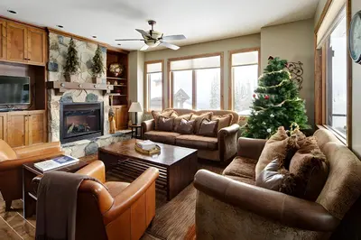 a living room with a christmas tree in it at Dwight Out Chalet with Hot Tub in Big White