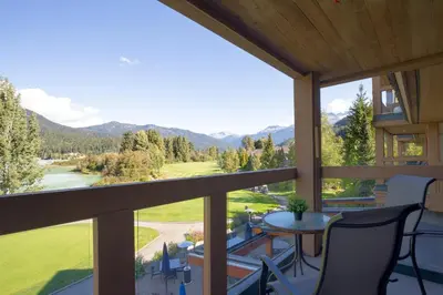 a balcony with a view of the mountains at 2BR in Nicklaus North Clubhouse, Lake and Mountain Views, Gas Fireplace, Parking in Whistler