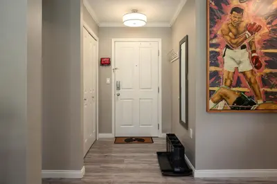 a hallway with a painting on the wall at 2BR in Nicklaus North Clubhouse, Lake and Mountain Views, Gas Fireplace, Parking in Whistler