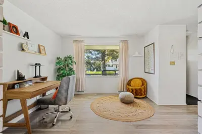 an office with a desk and chairs and a window at Digital Nomad's Calgary Inner City Gem 3Bd, 5Bed, Sleeps 8, Main Level in Calgary