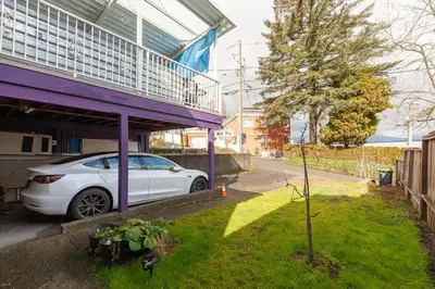 a white car parked in front of a building at PNE Delight in Vancouver