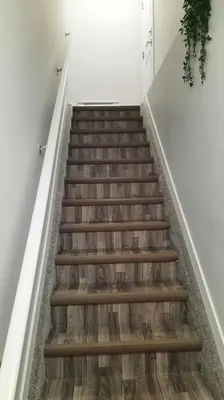 a stairway with wooden stairs in a room at Carsonway Basement Suite in Edmonton