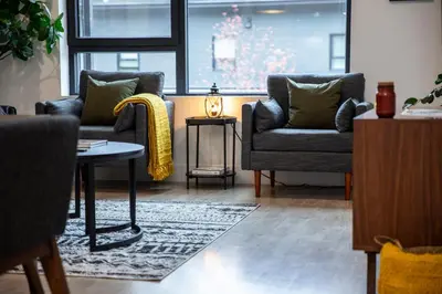 a living room with two chairs and a table at Cedar and Loam by Revelstoke Vacations in Revelstoke