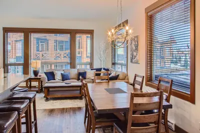 a living room with a table and a couch at Stonegate Resort Unit B408 in Big White