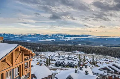 an aerial view of a ski resort with snow covered roofs at Stonegate Resort Unit B408 in Big White