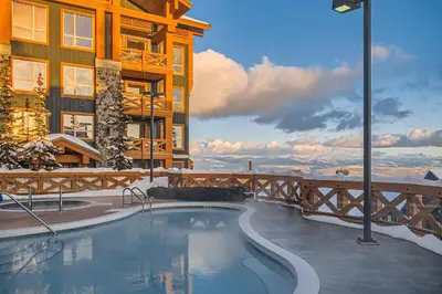 a swimming pool in front of a building at Stonegate Resort Unit C402 in Big White